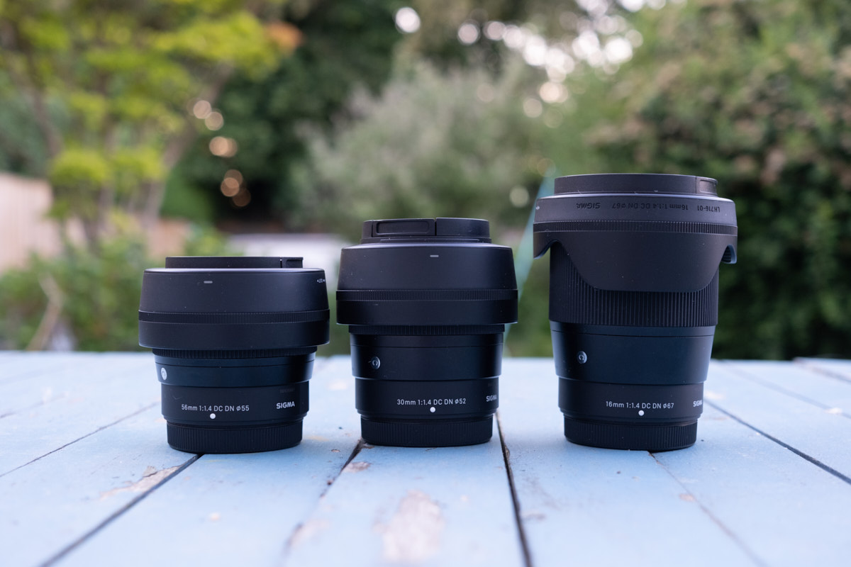 Sigma X-Mount lenses lined up on a table outside